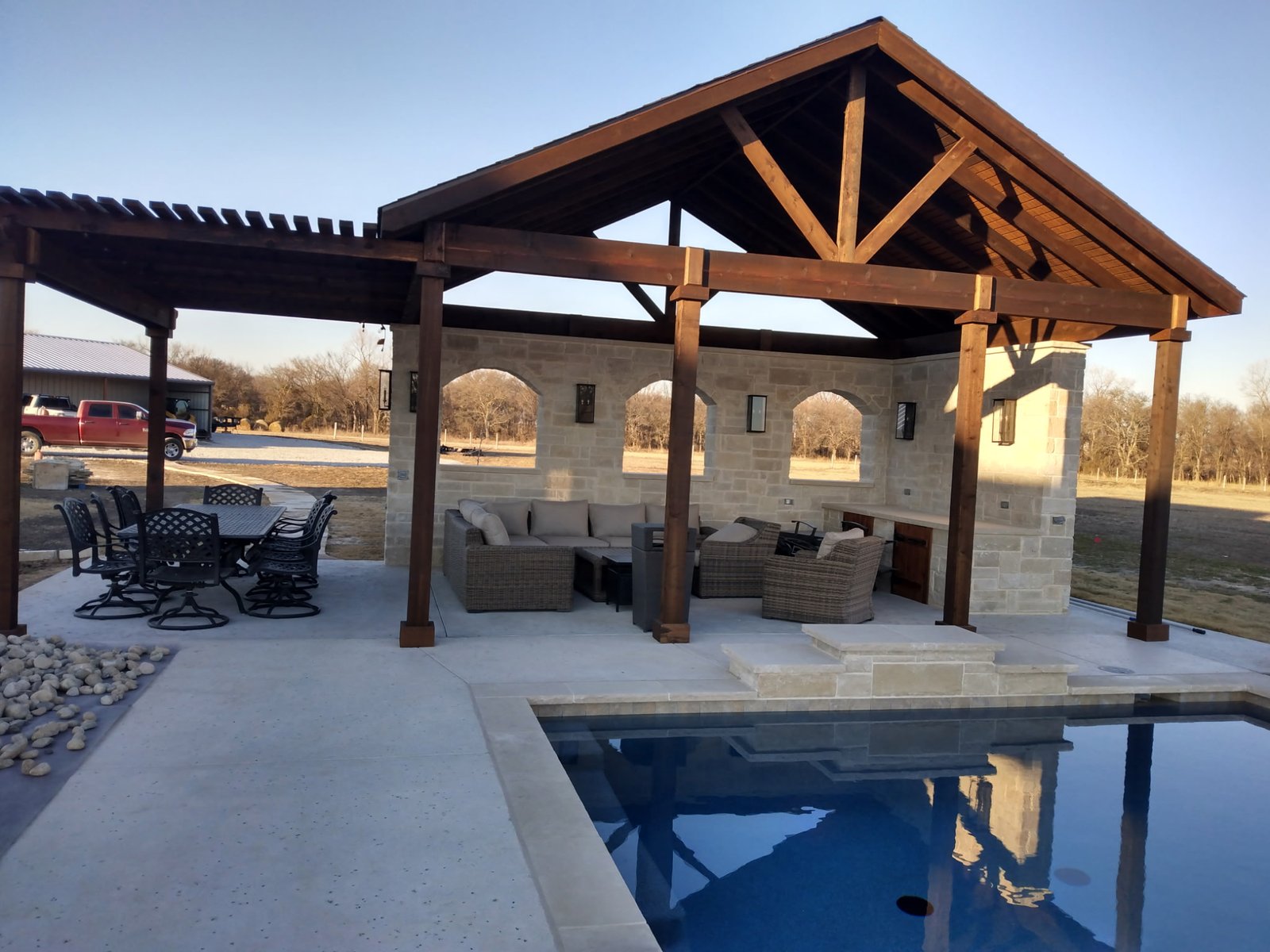 Outdoor living structure with stone columns and timber framing in Fort Worth, Texas
